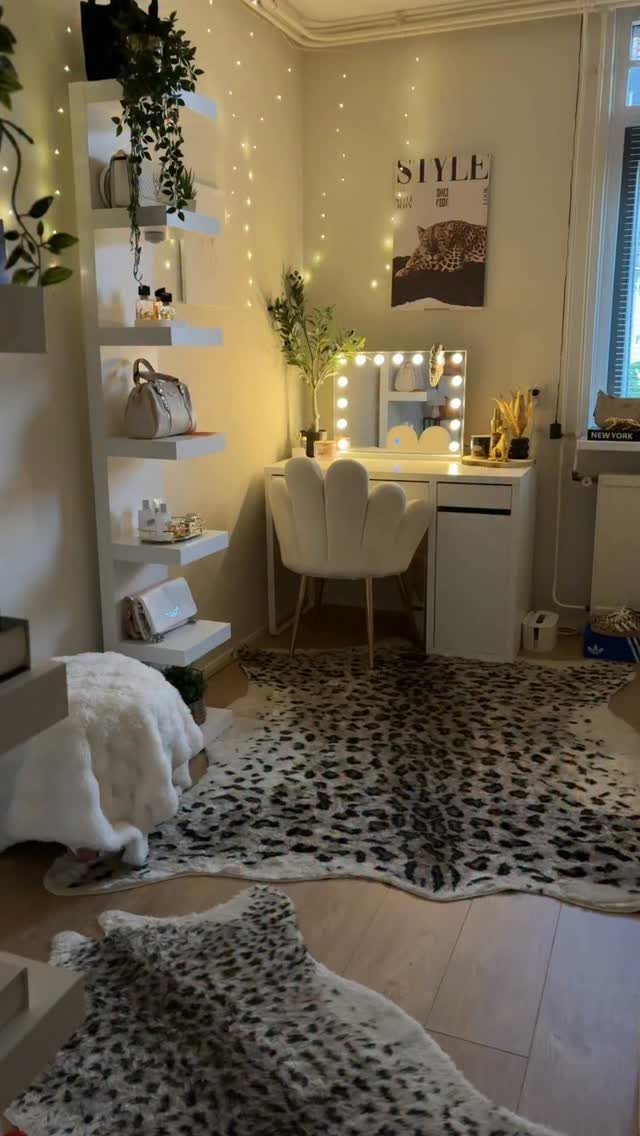 White vanity desk and scalloped chair set atop a large leopard print rug.