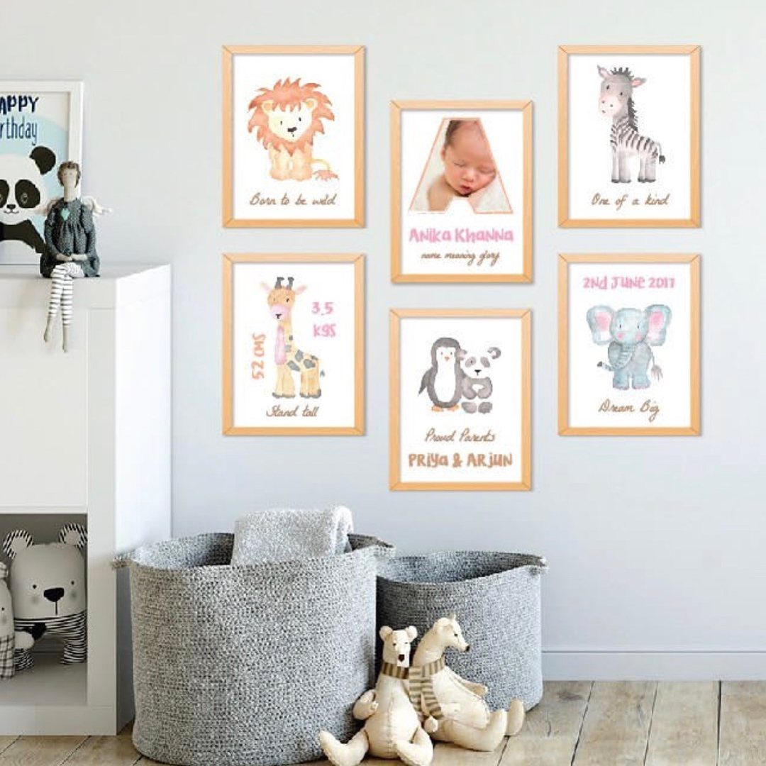 Nursery wall with animal art frames and grey storage bins with stuffed toys.