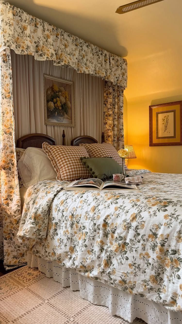 Floral print bedding and matching canopy curtains in a yellow bedroom