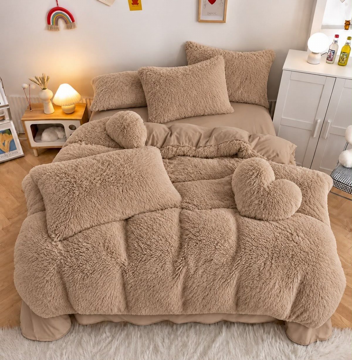 Plush tan faux fur bedding with heart-shaped pillows in a cozy bedroom