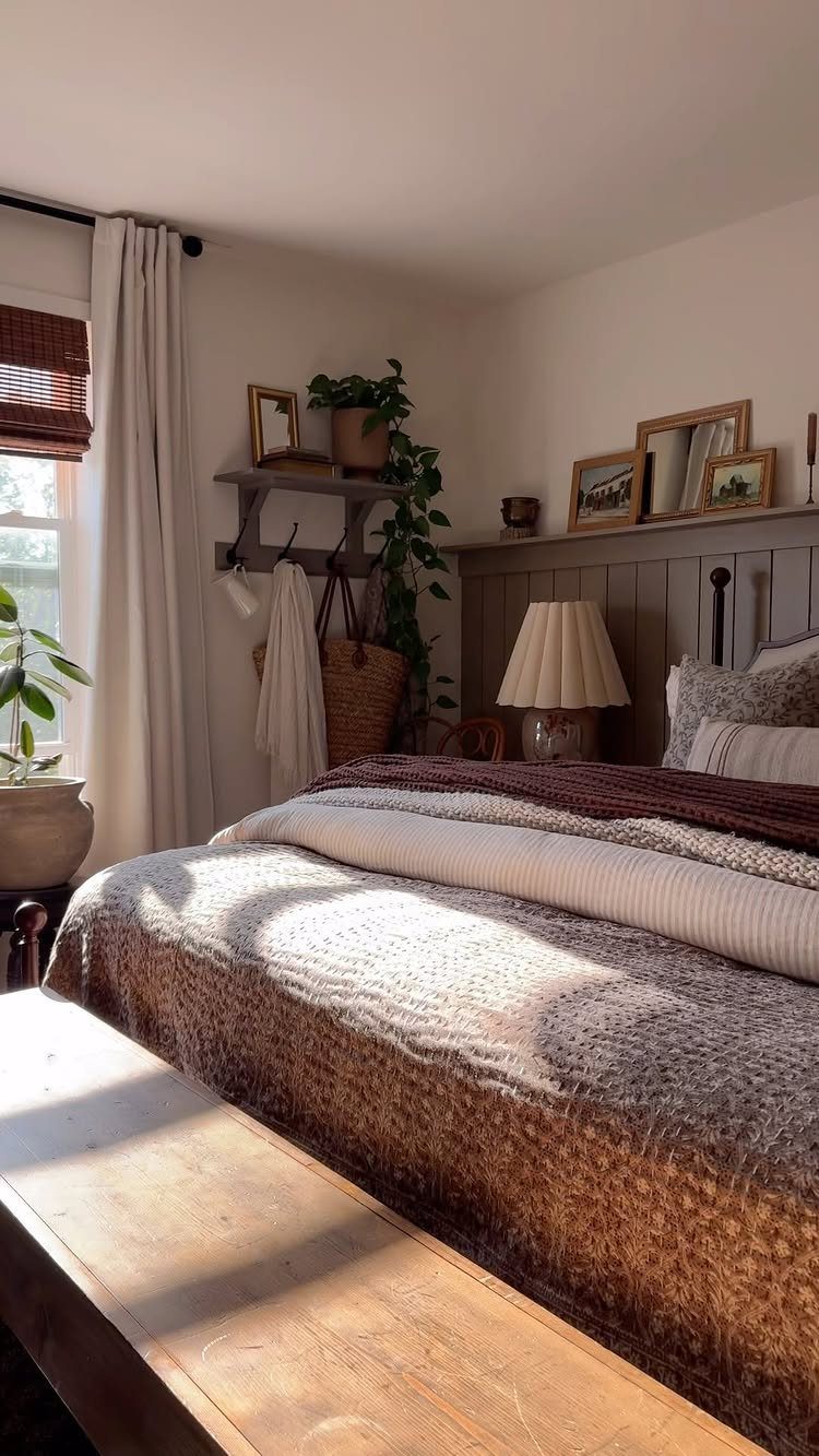 Bedroom with a grey vertical shiplap headboard, layered bedding, and wooden furniture.
