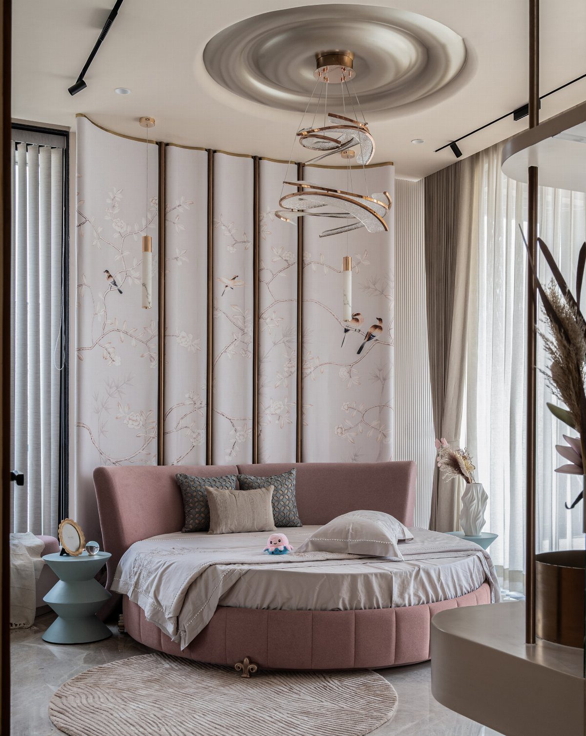 Round pink upholstered bed with soft curved edges in a luxury modern bedroom