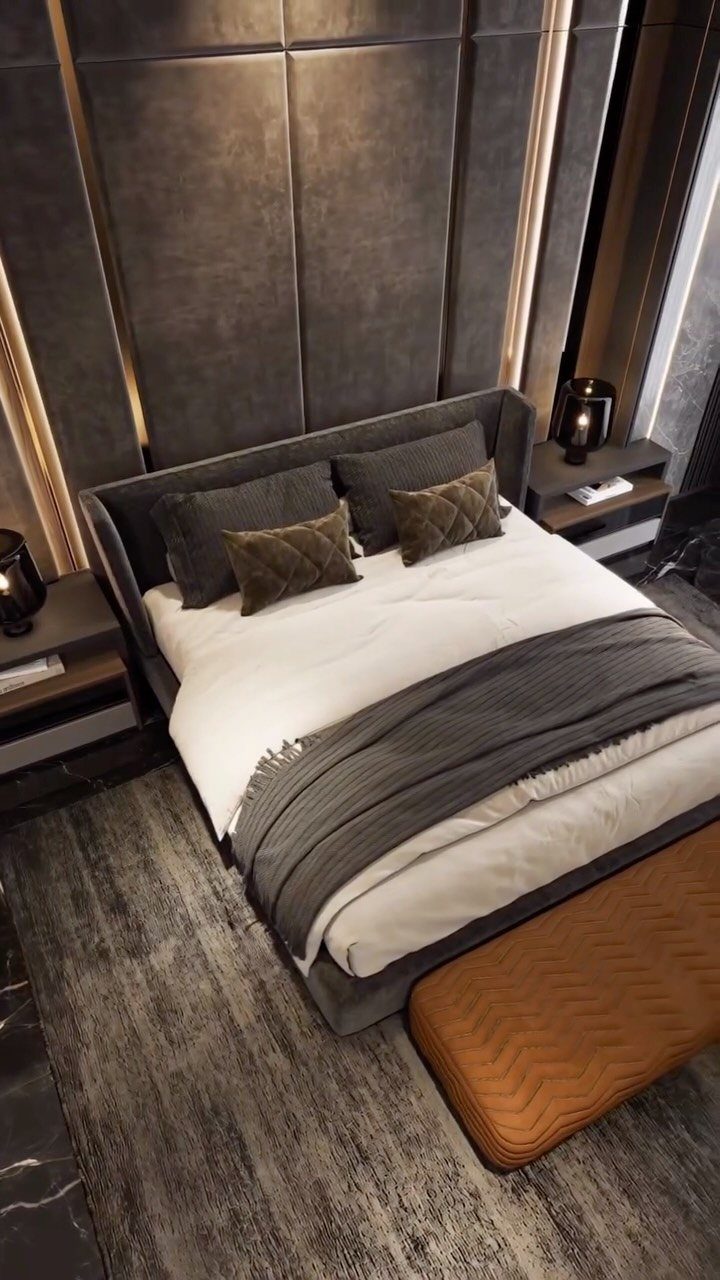 Modern bedroom with grey padded walls, grey bed, and brown leather bench.