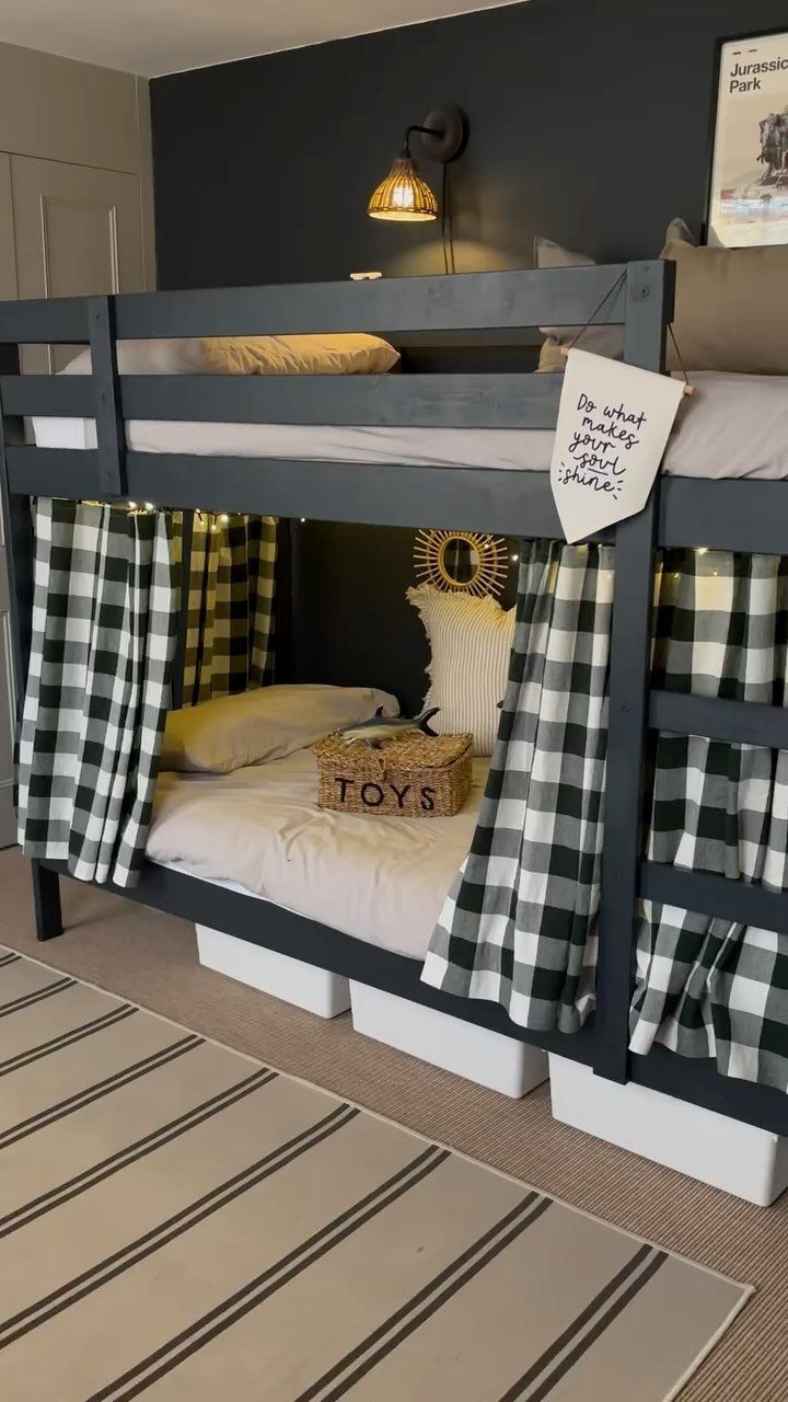 Dark grey bunk bed featuring black and white checkered curtains on the bottom bunk.