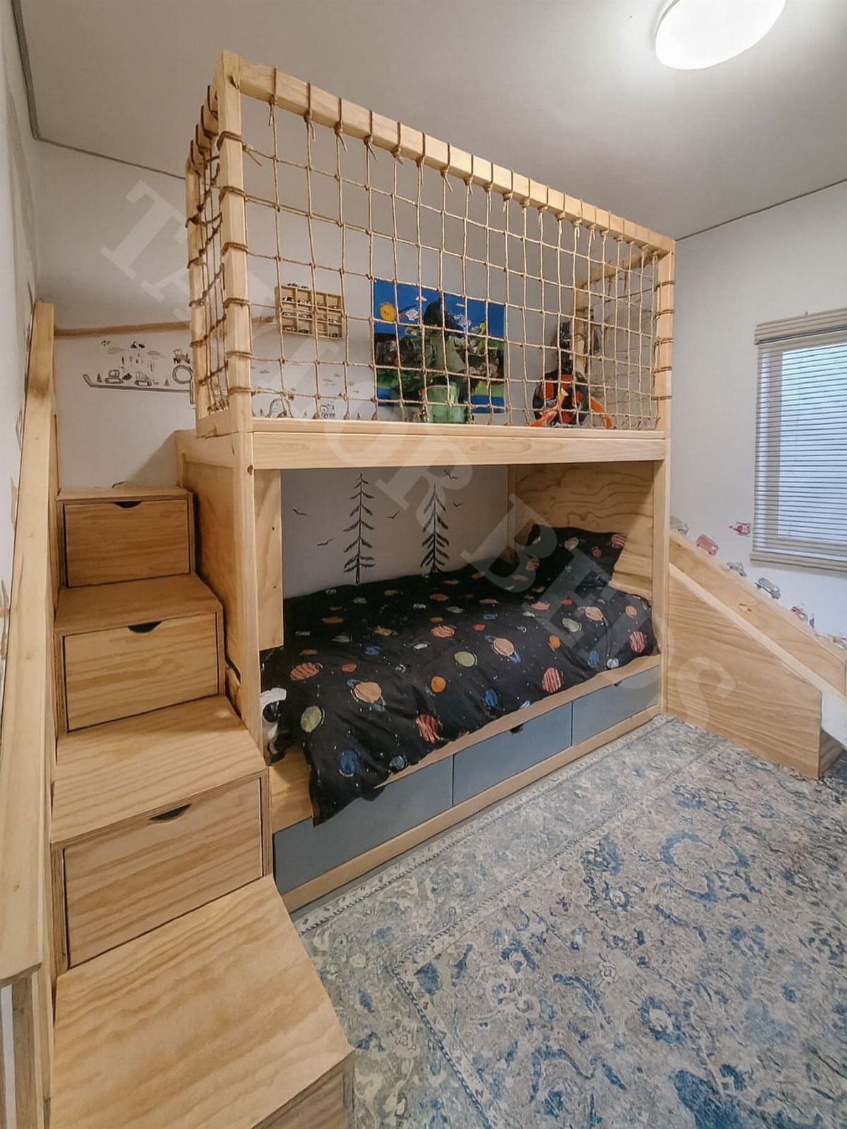 Wooden built-in bed with a play loft enclosed by rope netting on top.