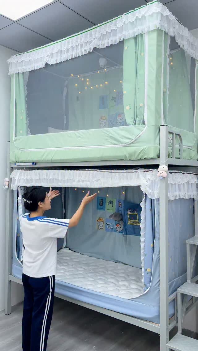 Bunk bed with light green and blue fabric tent enclosures and fairy lights.