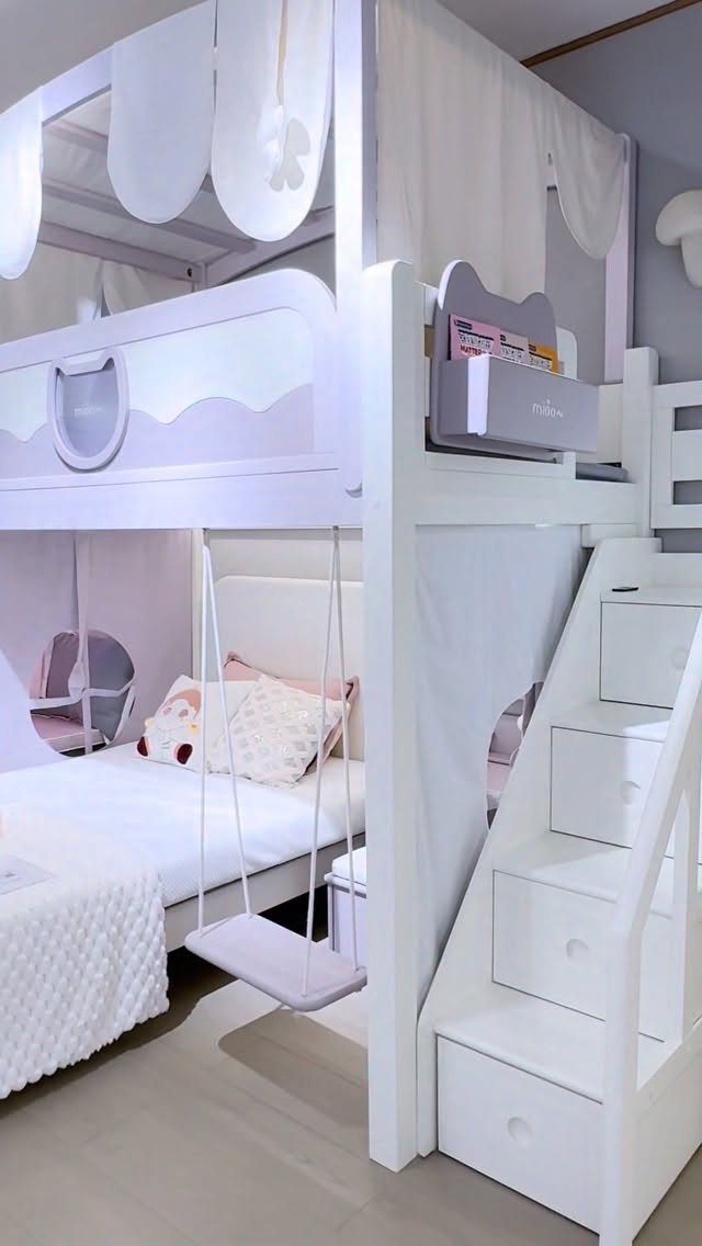 White bunk bed play area with integrated stairs, storage, and a hanging swing.