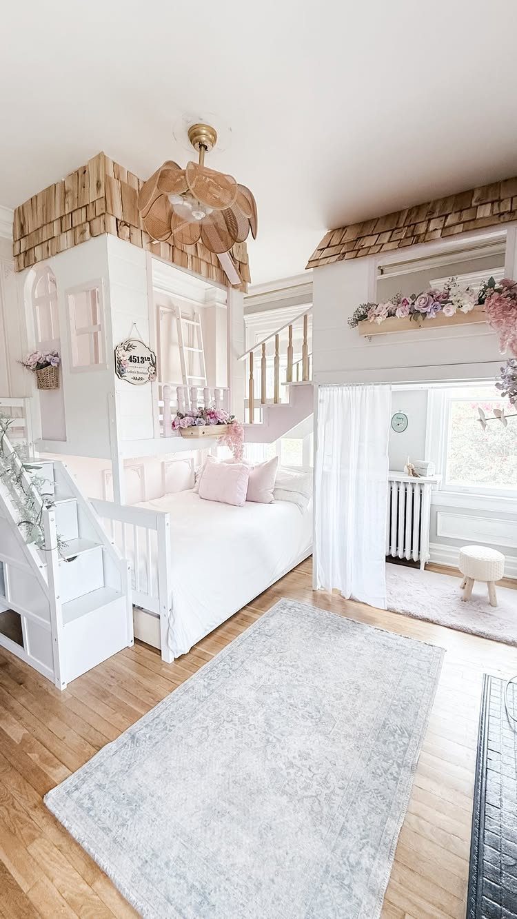 White wooden playhouse bed with a shingled roof in a bright child's bedroom.