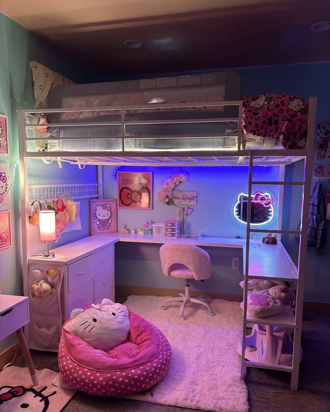 White metal loft bed with integrated L-shaped desk and pink bedroom decor
