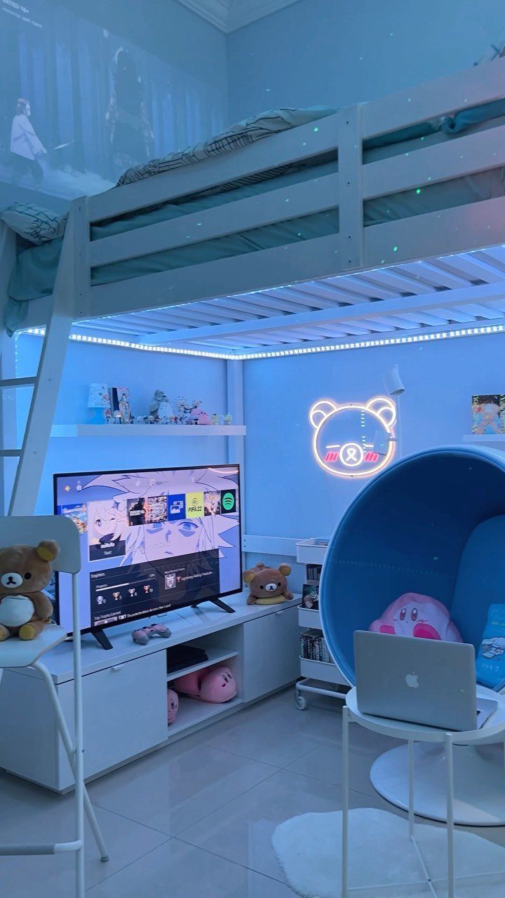 White loft bed over a gaming area with a blue pod chair and TV.