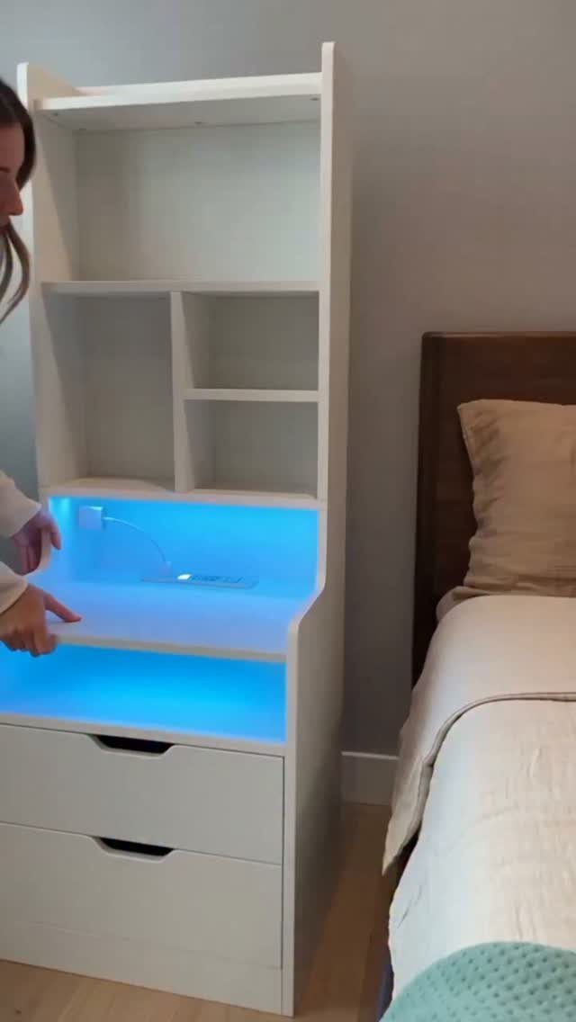 White wooden hutch with blue LED lighting next to a bed in a bedroom
