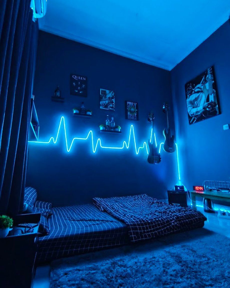 Blue neon heartbeat sign on a dark wall in a modern bedroom setup