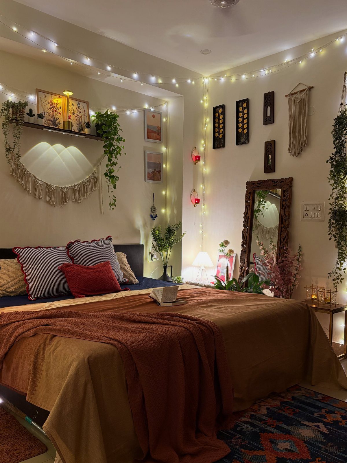 Bed with ochre bedding and rust throw in a cozy, decorated bedroom.