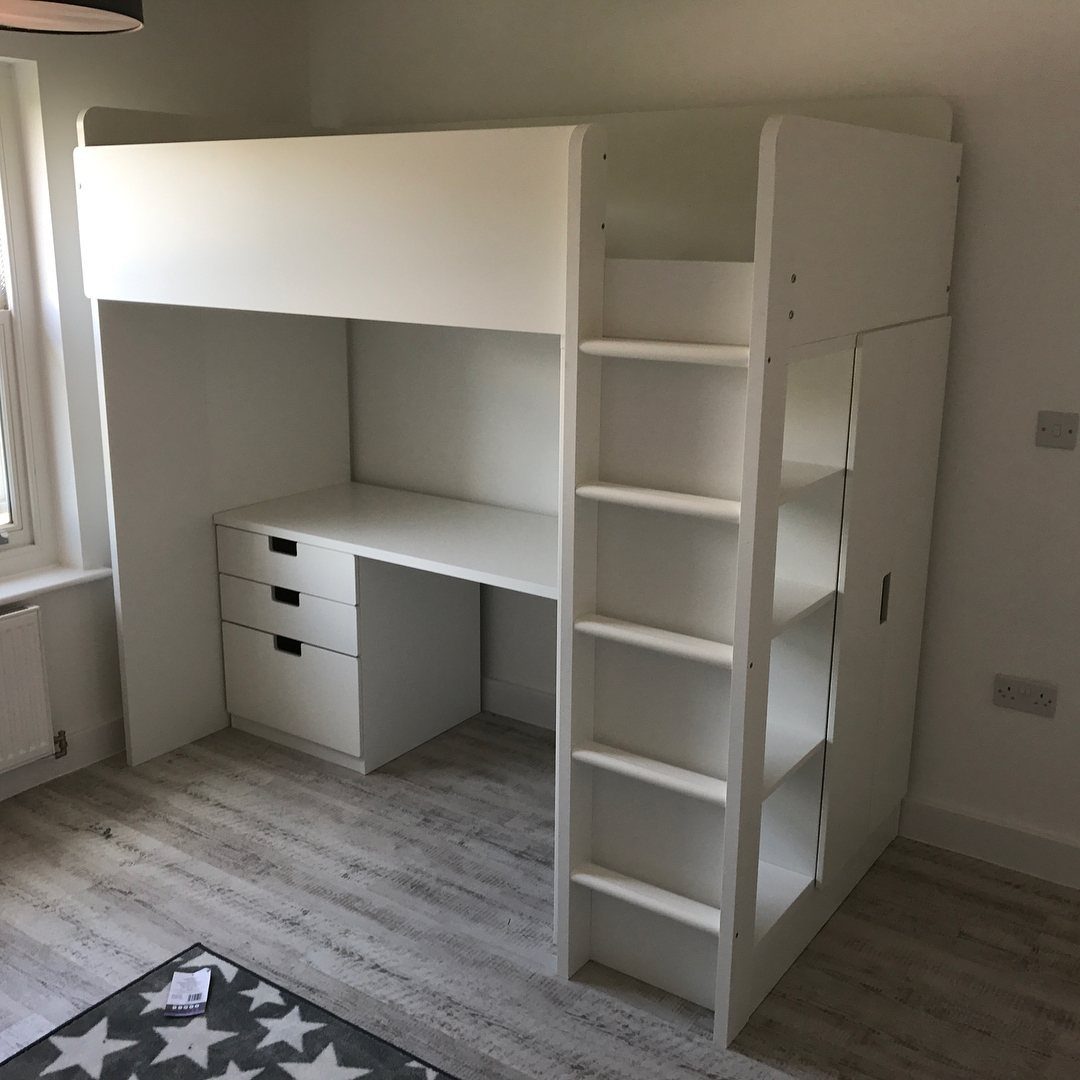 White wooden loft bed with integrated desk and shelving in a bright room.