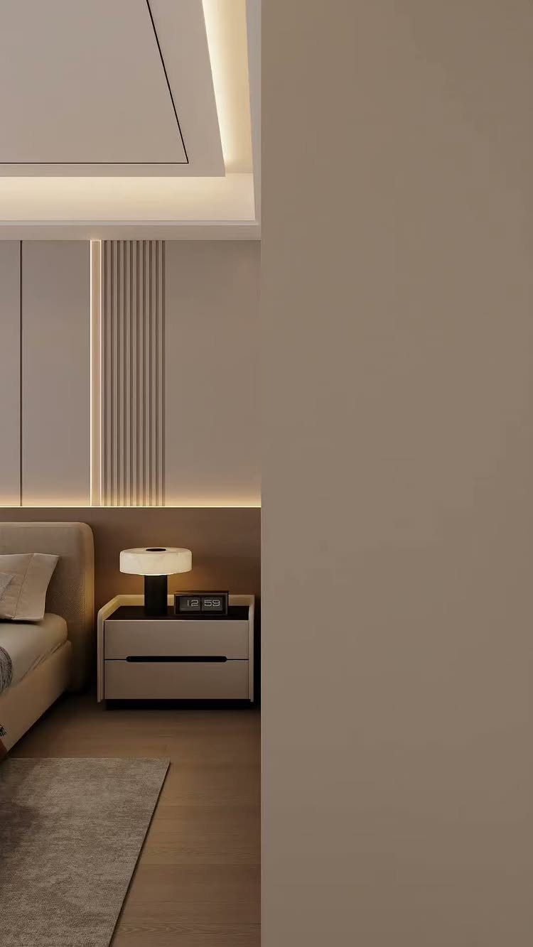 Modern bedroom with integrated LED strip lighting in the ceiling and wall panels.