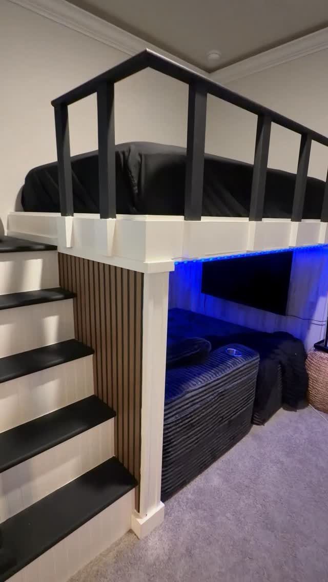 Loft bed with a secret room underneath featuring a sofa and blue lighting.
