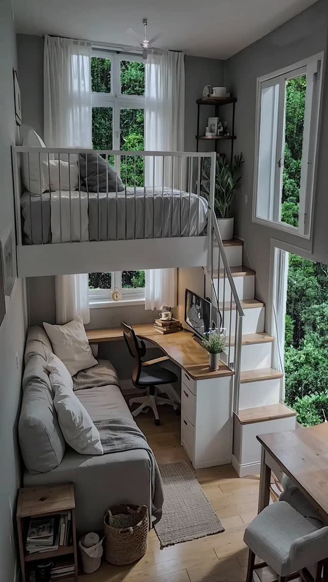 White loft bed in a corner with a desk and sofa underneath.