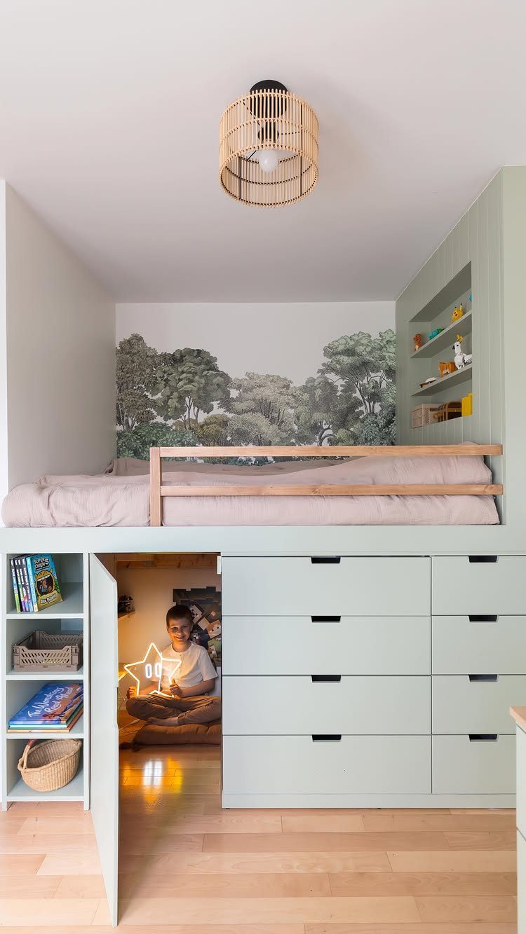 Loft bed with a cozy reading nook underneath where a child is sitting.