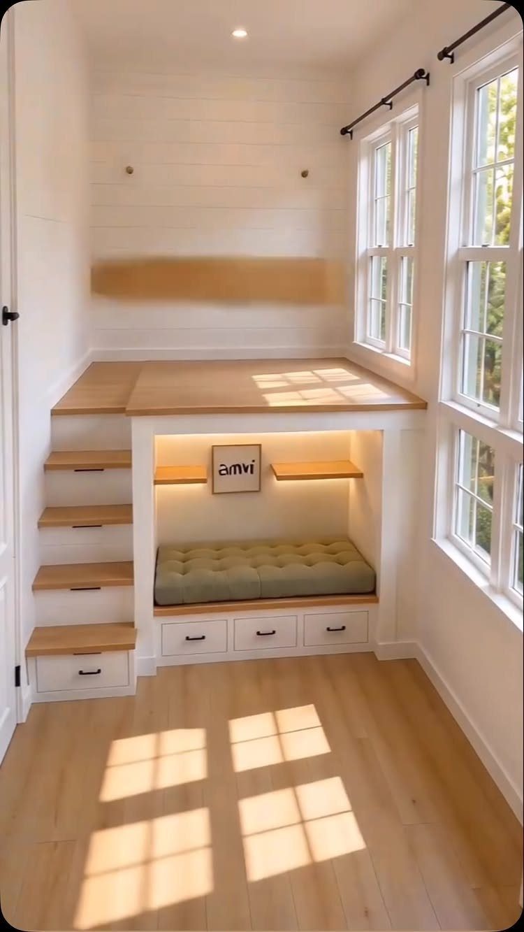 White wooden loft bed with a built-in reading nook and storage underneath.