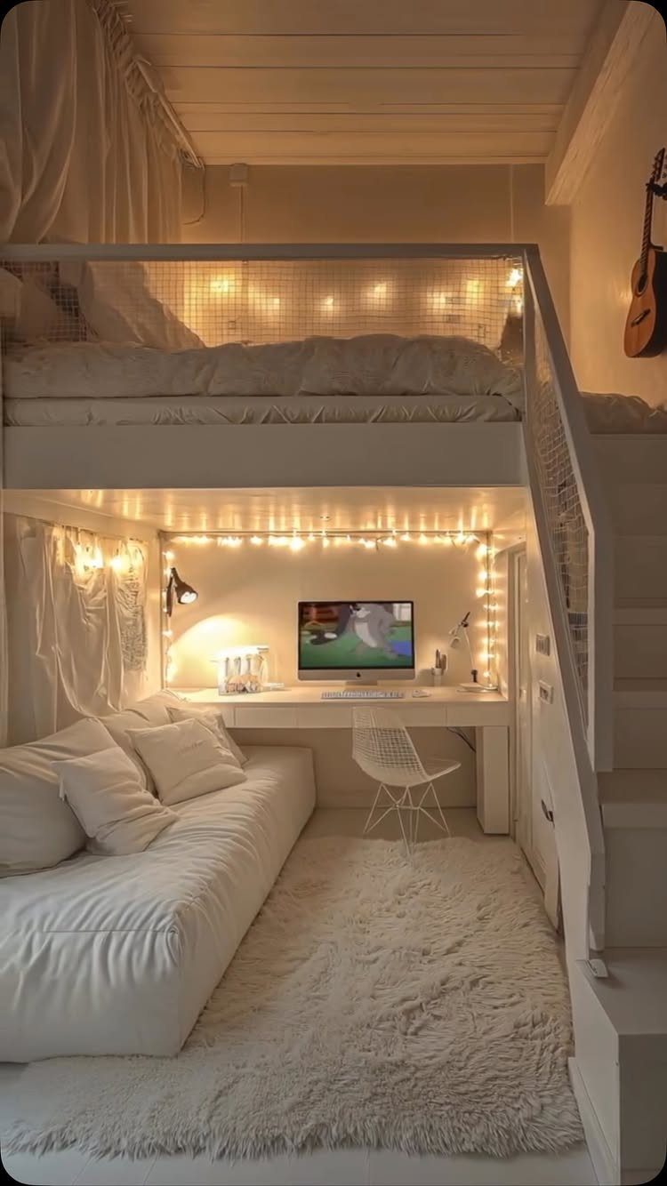 White loft bed with a desk and sofa underneath in a small room.