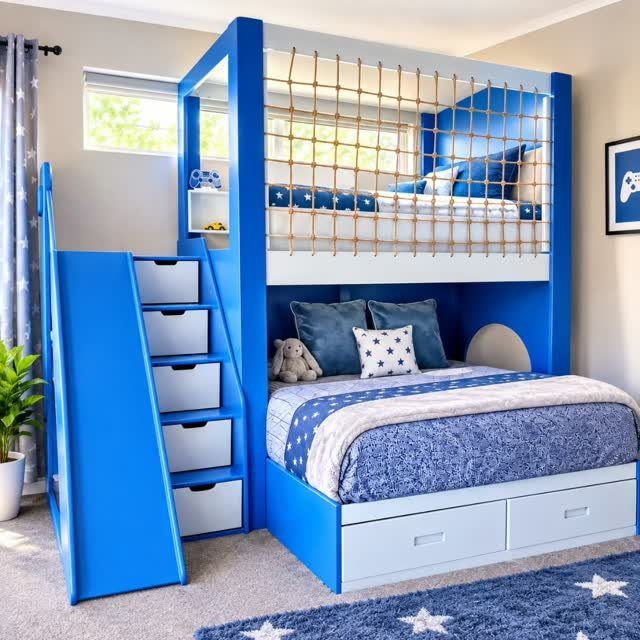 Blue bunk bed with a slide, rope safety net, and built-in storage drawers.