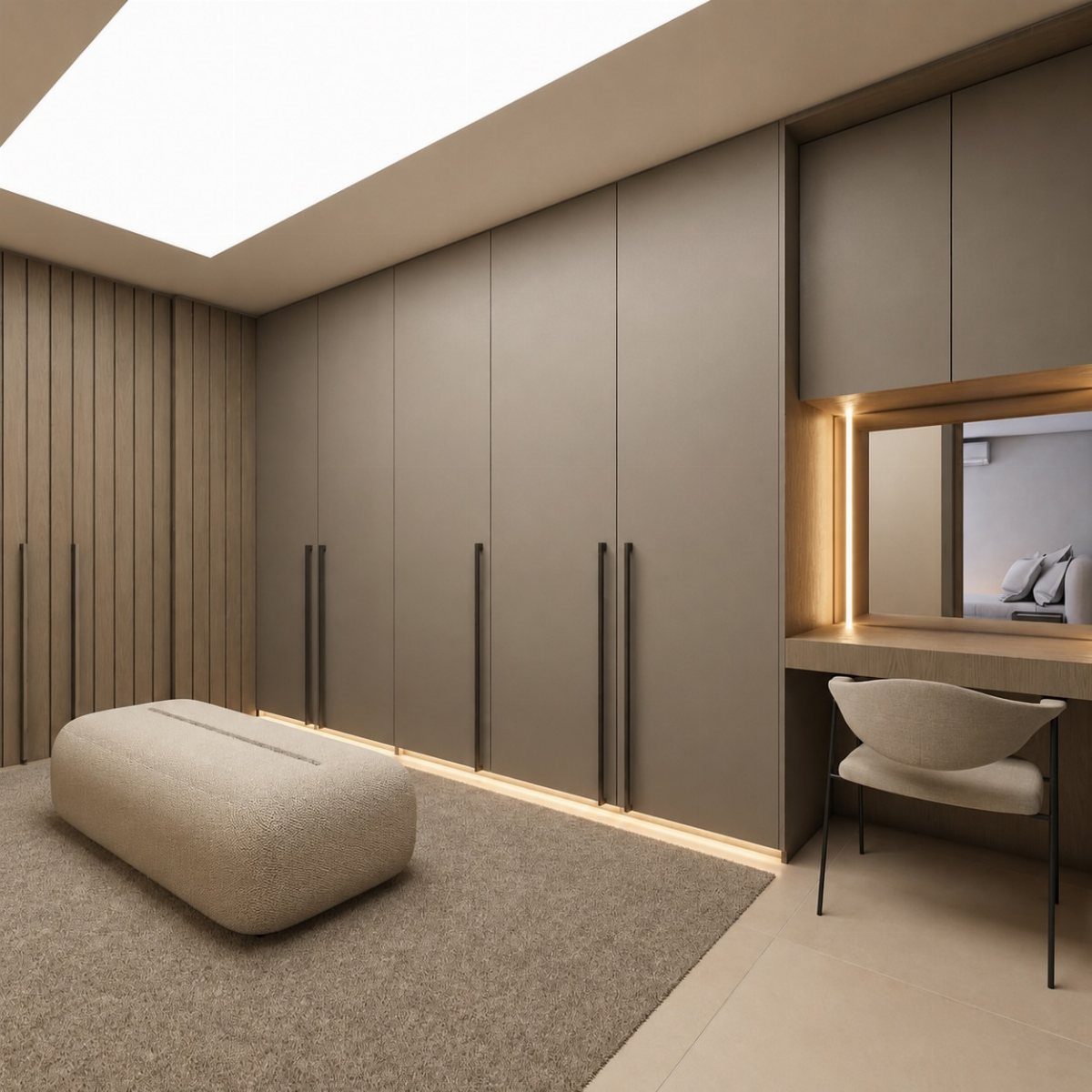 Floor-to-ceiling built-in wardrobes in taupe with a beige ottoman and dressing table.