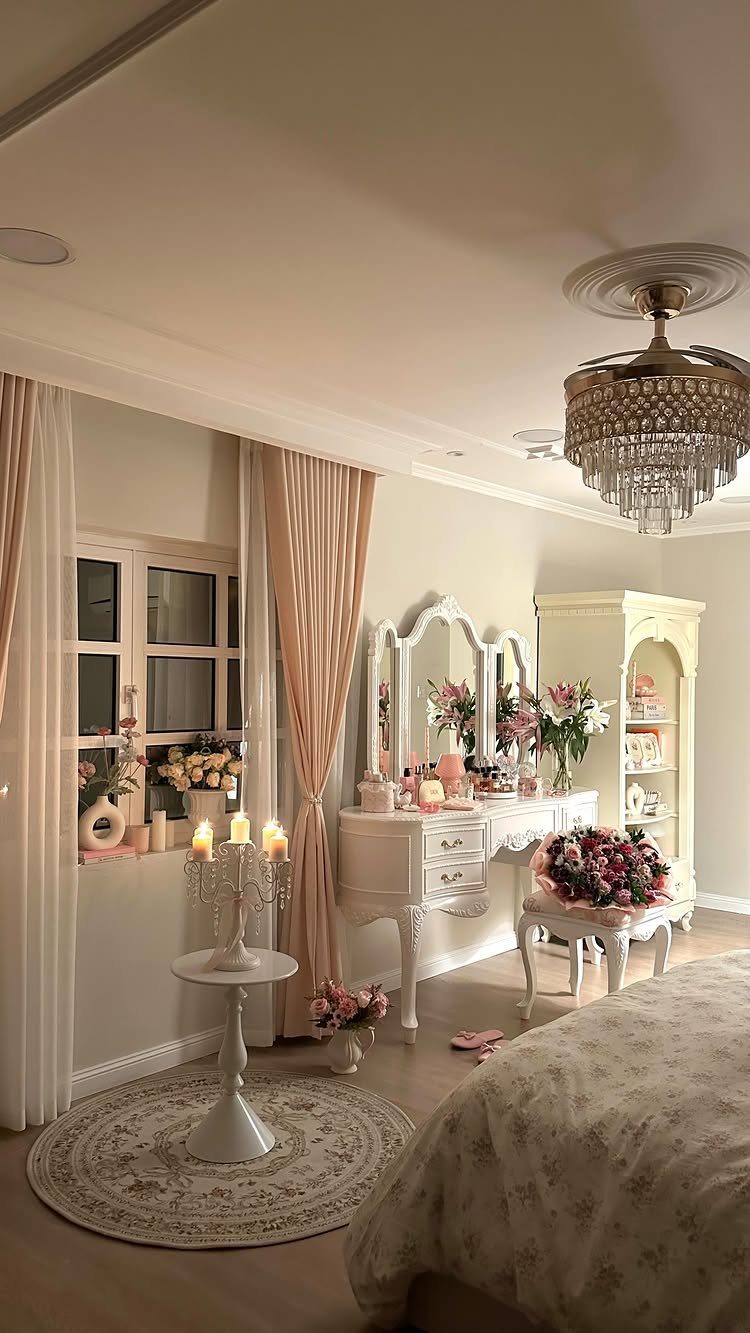 Fresh pink and white flowers decorating a white luxury bedroom dressing table setup.