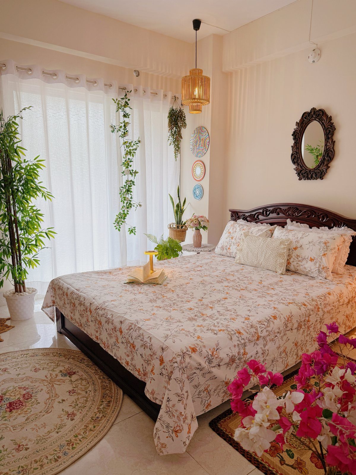 Bedroom with floral bedding and various indoor green plants for nature-inspired decor.