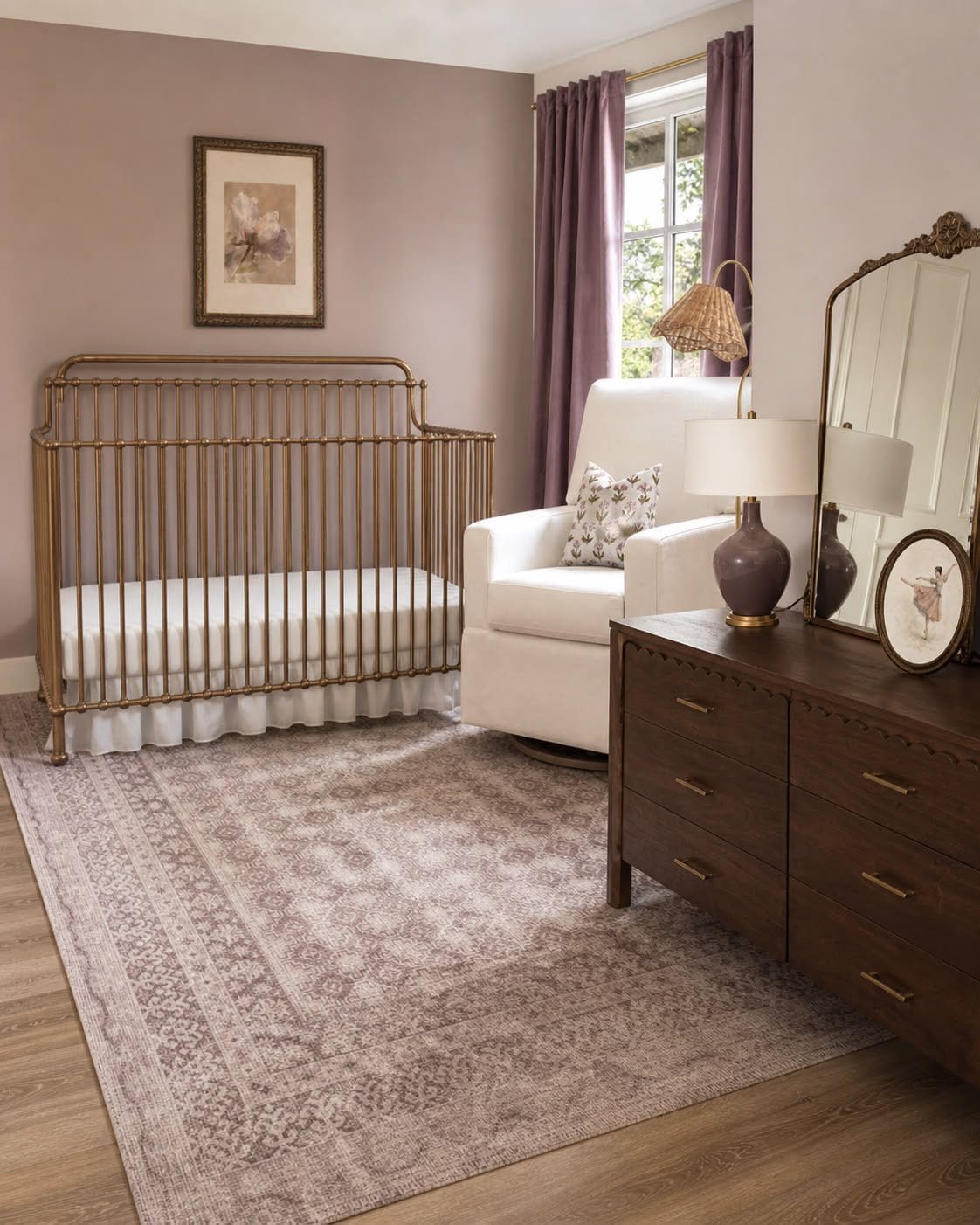 Gold metal crib and dark wood dresser in a mauve toned nursery room.