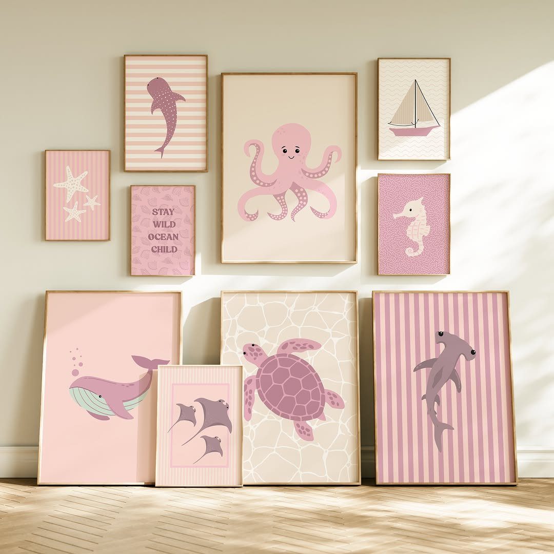 Framed ocean art prints with pink sea creatures arranged on a gallery wall.