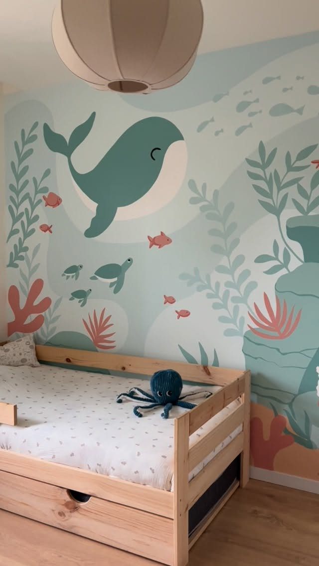 Underwater wall mural with a whale and sea creatures in a child's bedroom