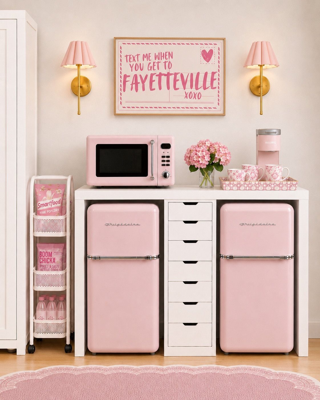 Pink and white dorm room setup with matching mini fridges and microwave.