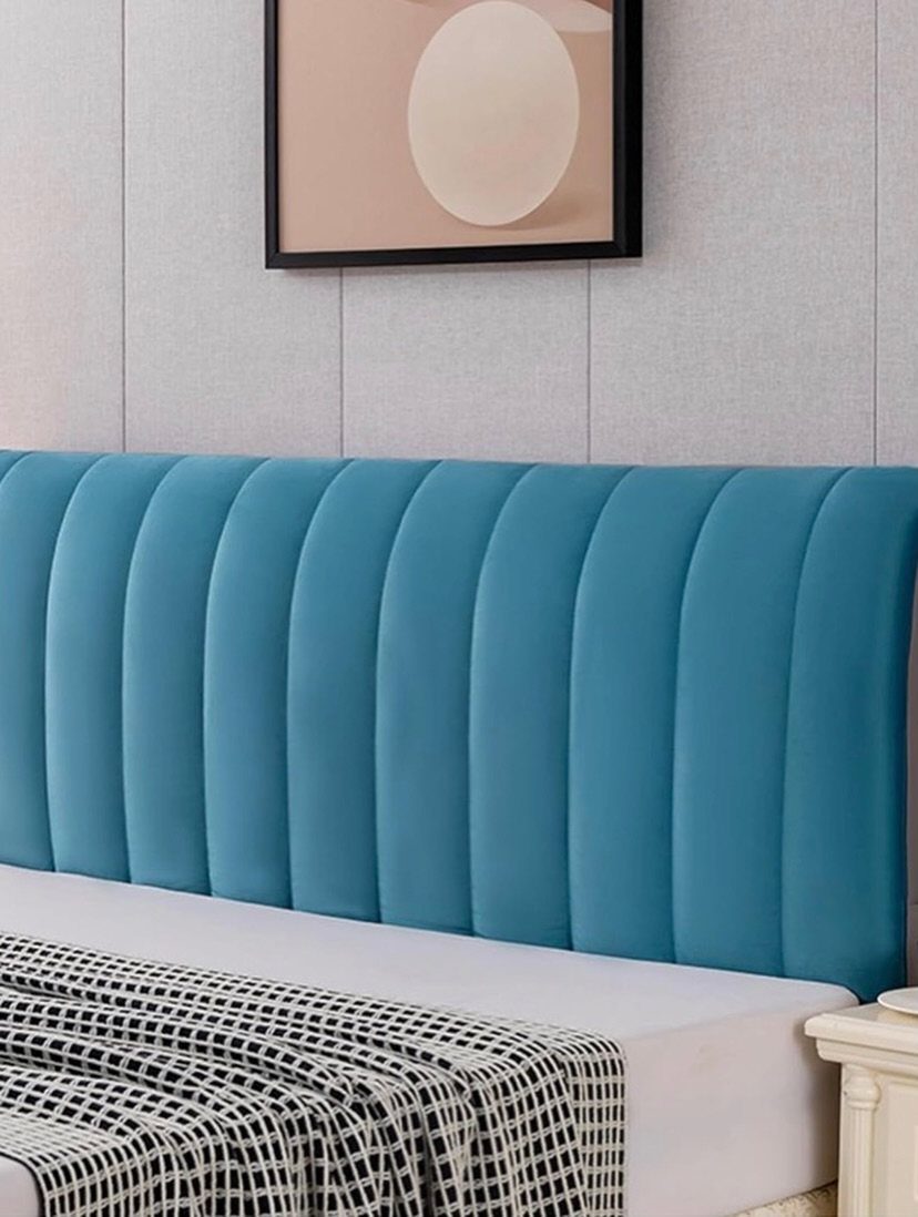 Teal blue velvet channel tufted headboard behind a bed with checkered bedding.