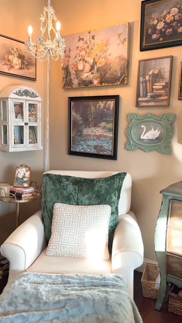 White armchair with plush pillows and throw blanket in a cozy reading corner.