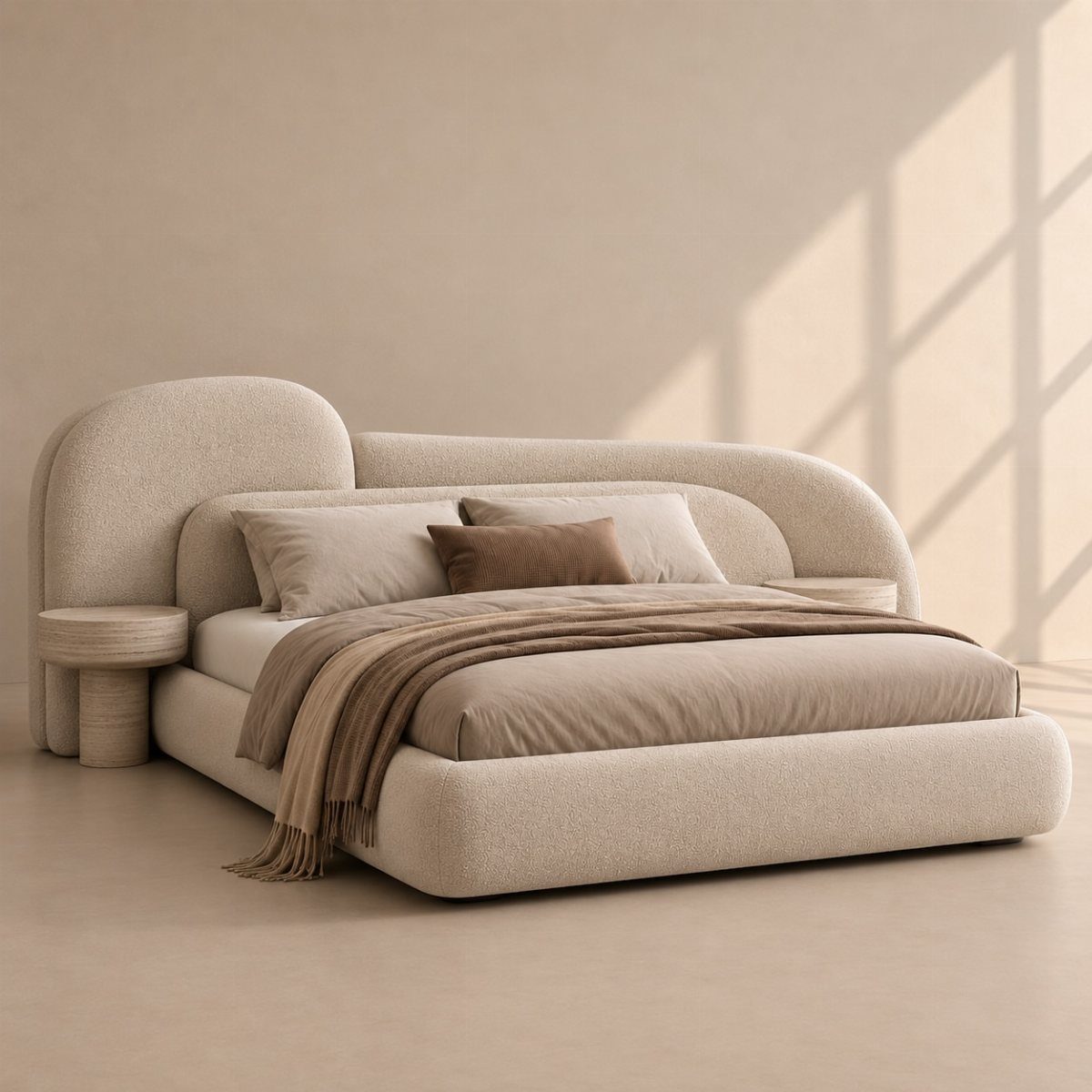 Curved beige upholstered bed and round nightstand in a neutral modern bedroom