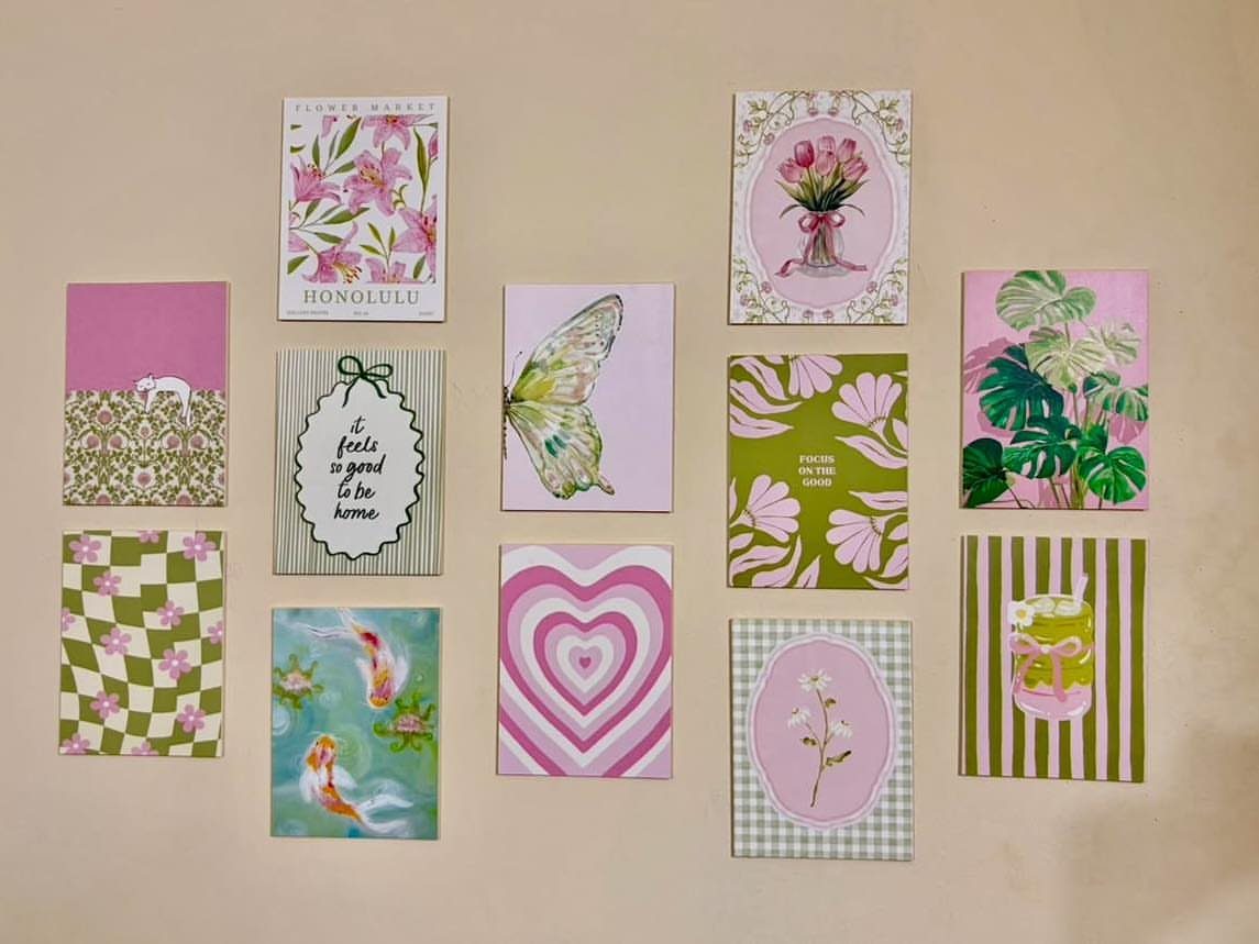 Small pink and green art prints arranged on a neutral beige wall.