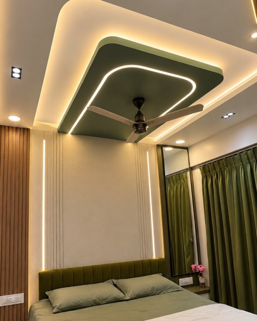 Modern bedroom with a green recessed ceiling, LED lighting, and matching green decor.