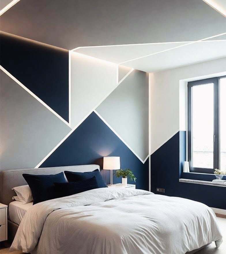 Modern bedroom with navy blue and light grey geometric two-tone painted walls.