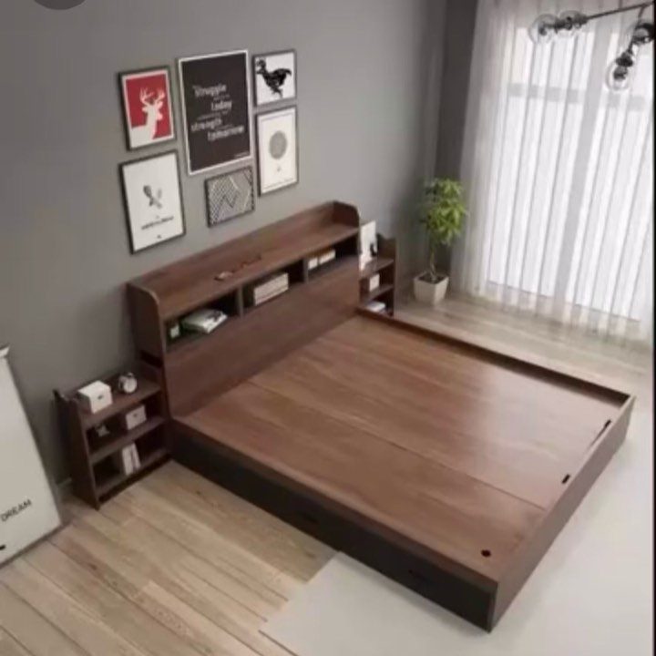 Brown wooden platform bed with built-in headboard shelving in a modern grey bedroom.