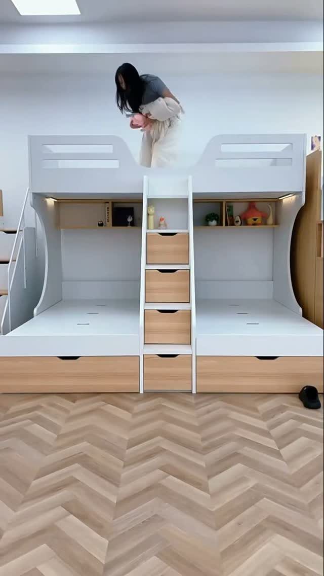 Twin over twin bunk bed with integrated storage drawers and herringbone wood floors.