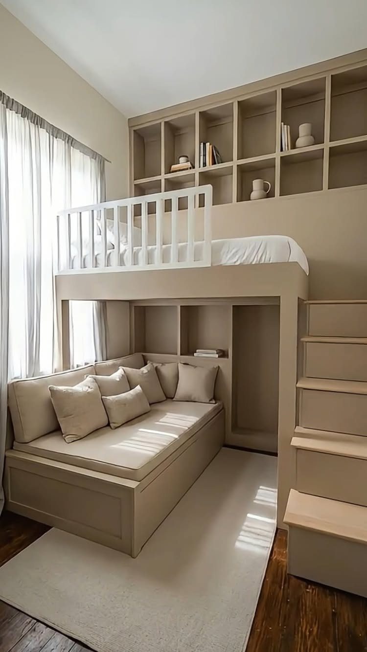 Beige loft bed with a built-in sofa and stairs in a neutral room.