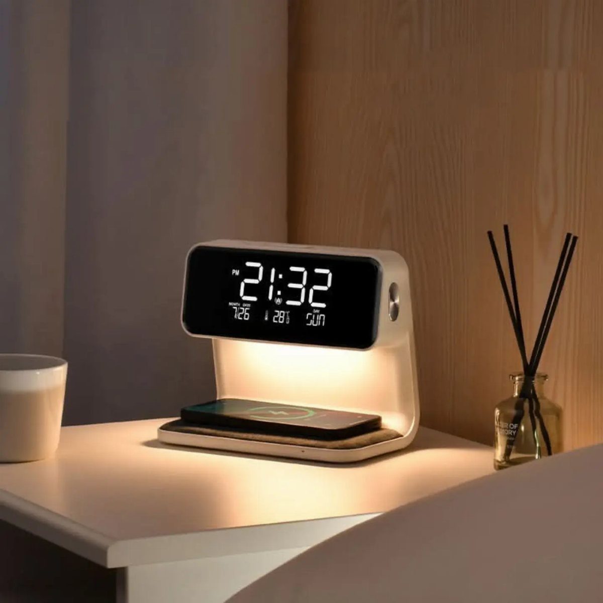 Digital alarm clock with integrated lamp and wireless phone charger on a bedside table.