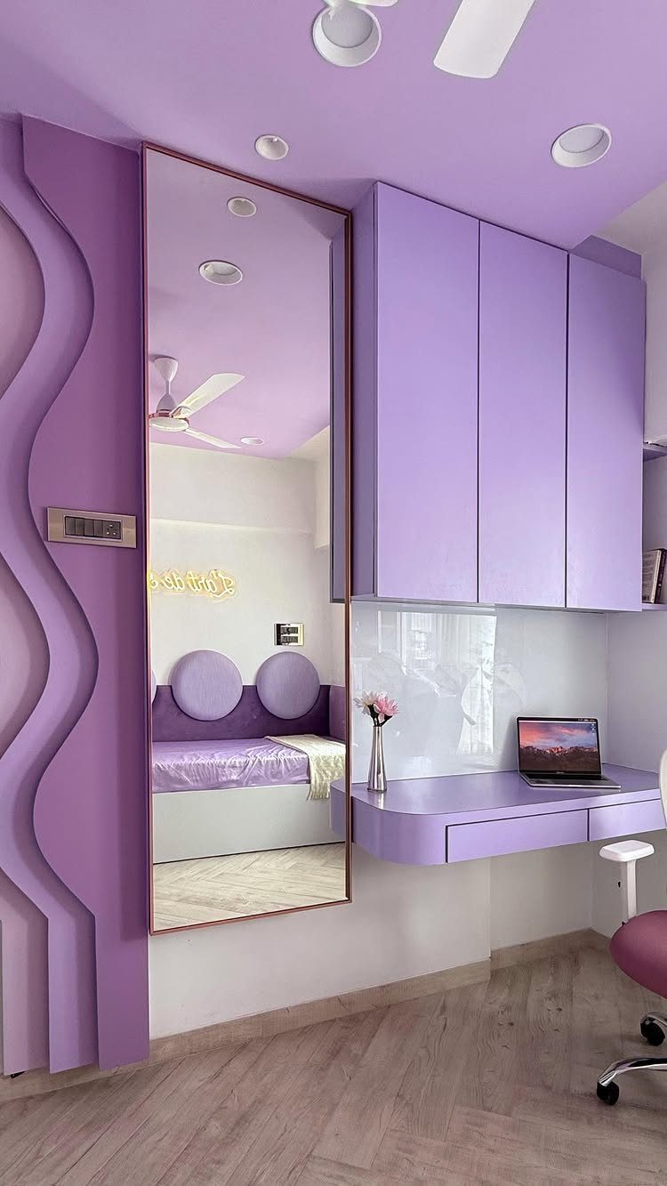 Lavender purple bedroom with matching walls, ceiling, and built-in desk and cabinets.