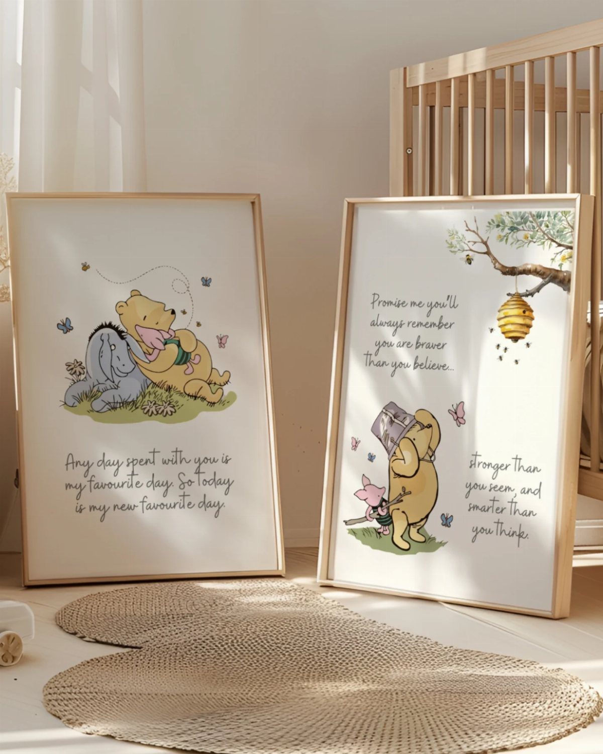 Two framed Winnie the Pooh prints with quotes leaning against a nursery wall.