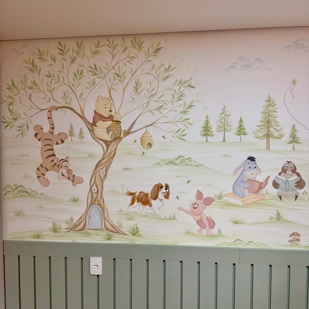 Winnie the Pooh and friends wall mural in a nursery with green wainscoting